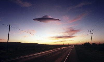 Alien aircraft floating above highway (Digital Composite)